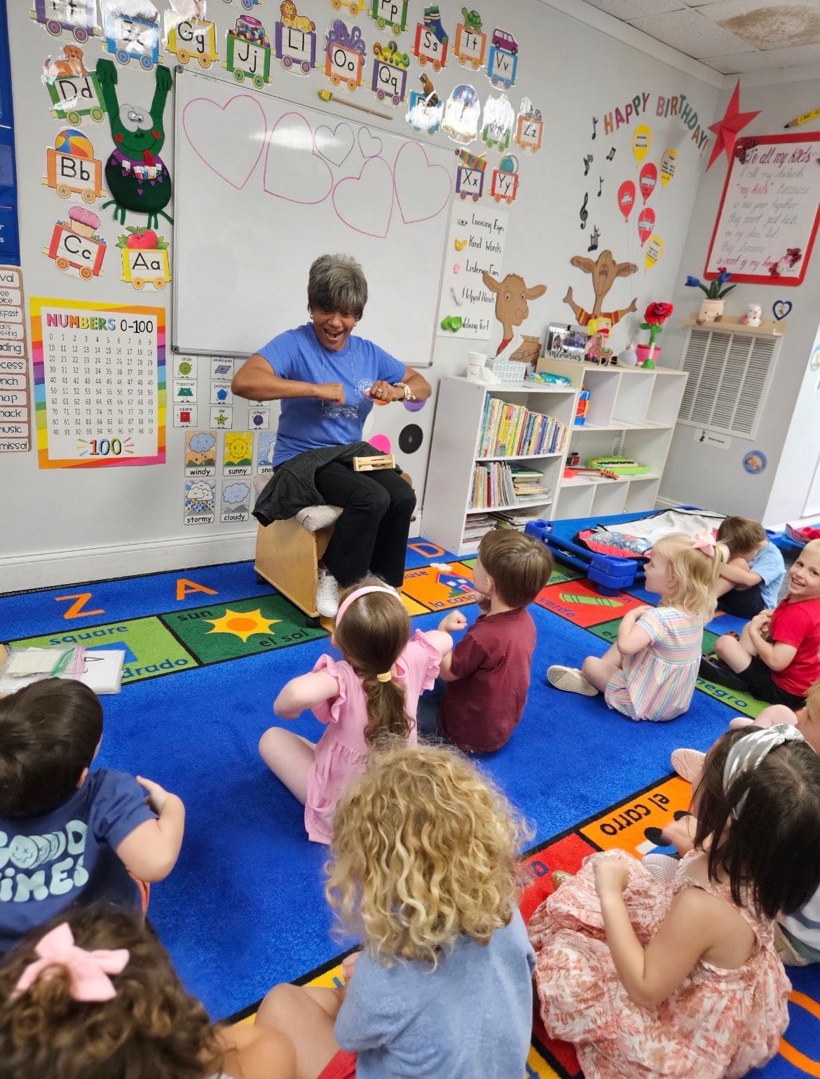 Teacher with young students in a nurturing classroom environment